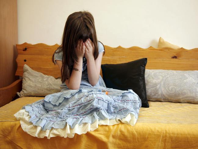 Sad girl on a sofa. Child. Generic image.