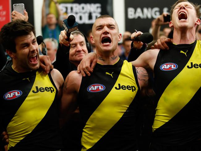 Trent Cotchin, Dustin Martin and Jack Riewoldt of the Tigers sing the team song