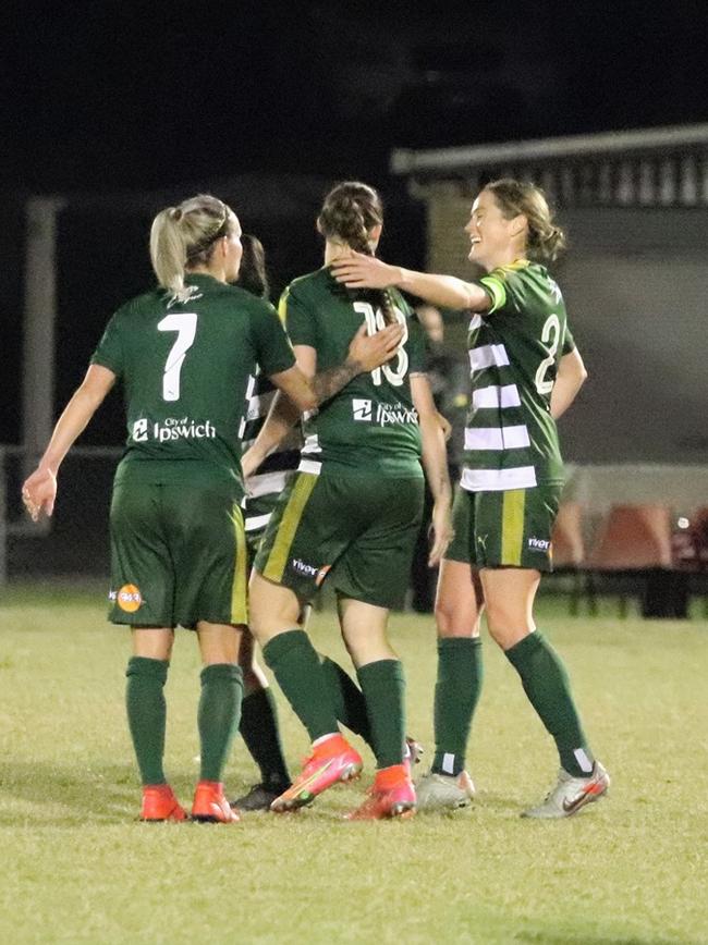 Western Pride players Kate Webb and captain Meaghan McElligott help celebrate one of three Abbey Lloyd goals in their 3-2 victory over The Gap in the NPLW competition. Picture: Kerryn Hyett