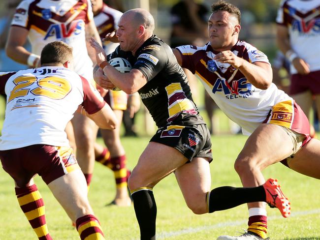 Former NRL player Heath LeStrange makes a break against Guildford.