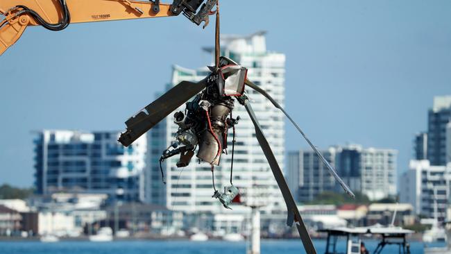 Queensland Police and ATSB Officers recover the wreckage after four people were killed and many more injured after two helicopters collided near Sea World on the Gold Coast. Picture: Scott Powick