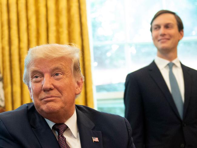 Mr Trump and Jared Kushner enjoy the announcement. Picture: AFP