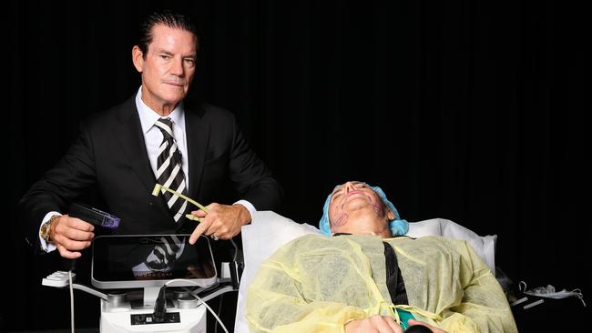 Dr Stephen Mulholland, plastic surgeon to the stars, demonstrating his new technical device for non-invasive skin treatments on stage. Picture: Daily Telegraph / Gaye Gerard