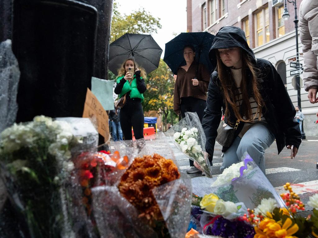 People place flower tributes to actor Matthew Perry outside the apartment building which was used as the exterior shot in Friends in New York. Picture: AFP