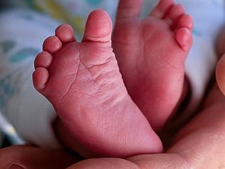 Holding newborn foot