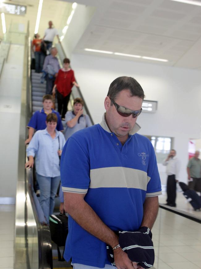 Conman Matthew Charles Tanner, alias James Hall, being escorted through Adelaide Airport after being extradited from Perth.