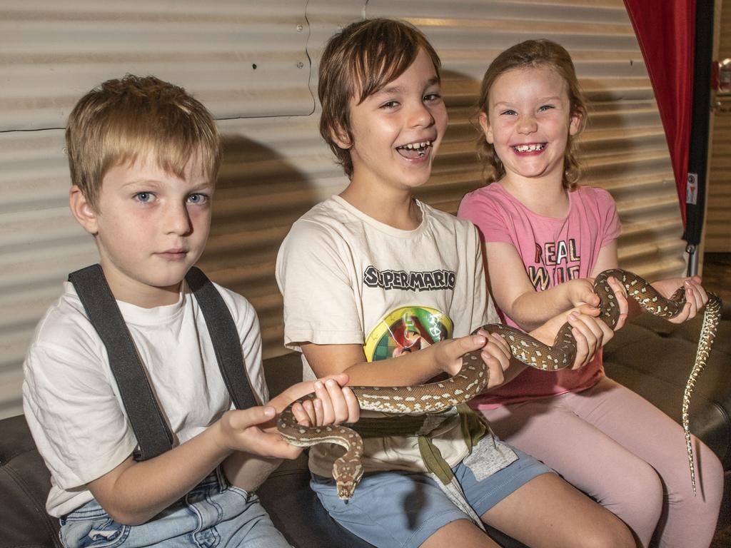 (from left) cousins James Hazel, Quinn Paterson and Lexie Paterson with Nutella the Bredli python. Cobb+Co Museum Easter school holiday program Wildlife Rangers with Wildcall Wildlife Shows. Monday, April 4, 2022. Picture: Nev Madsen.