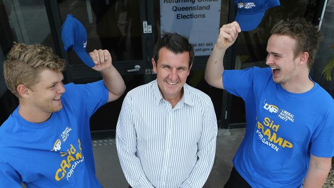 Campaign workers Kristian Marlow (left) and Jackson Franks (right) salute the victor and their candidate Sid Cramp outside the ballot counting office in Nerang. Picture Glenn Hampson