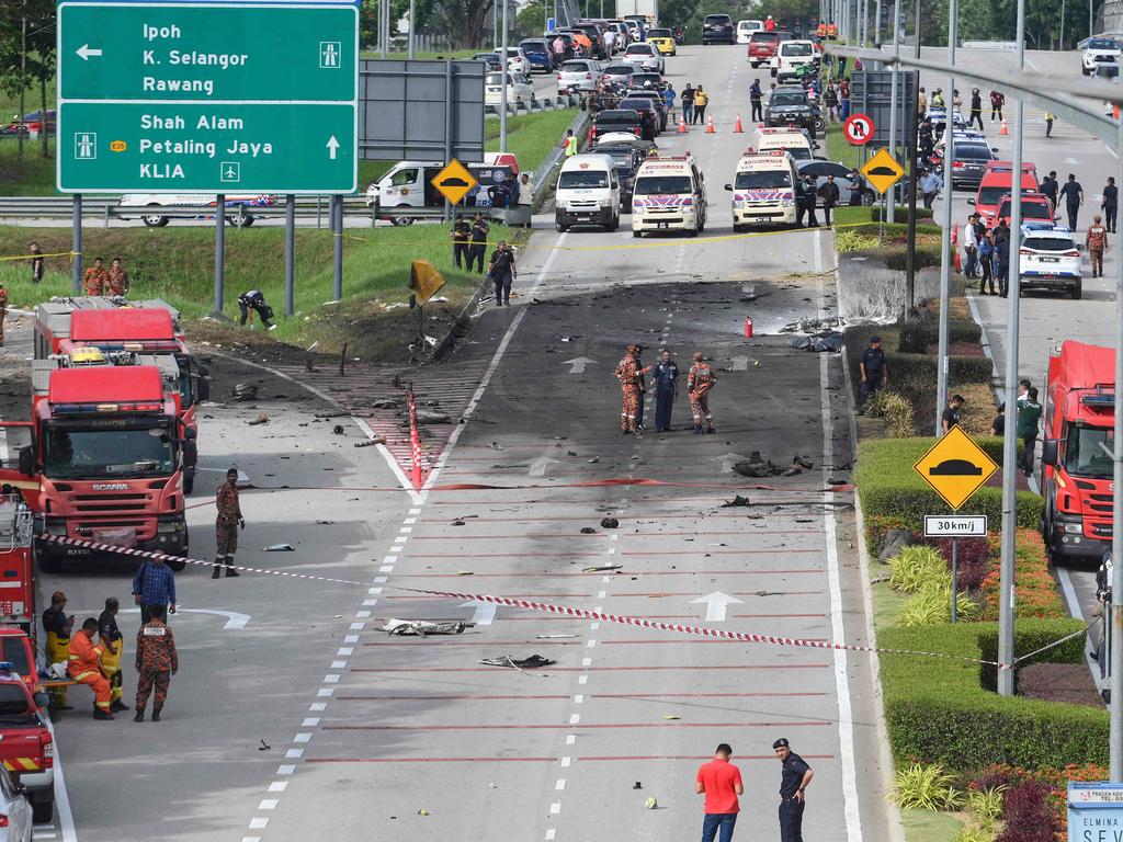 A light plane crashed on a street in Malaysia's central Selangor state on Thursday, killing eight people on board and two motorists on the ground, authorities said. (Photo by Muhammad Lutfi / AFP)