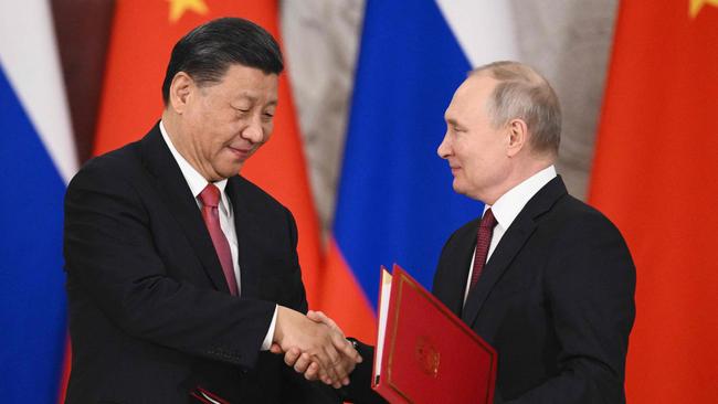 Russian President Vladimir Putin and China's President Xi Jinping shake hands following their talks at the Kremlin in Moscow. Picture: AFP