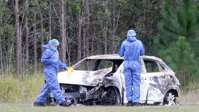 Police at the scene with the allegedly stolen car, found burned out in Moodlu, north of the crash.