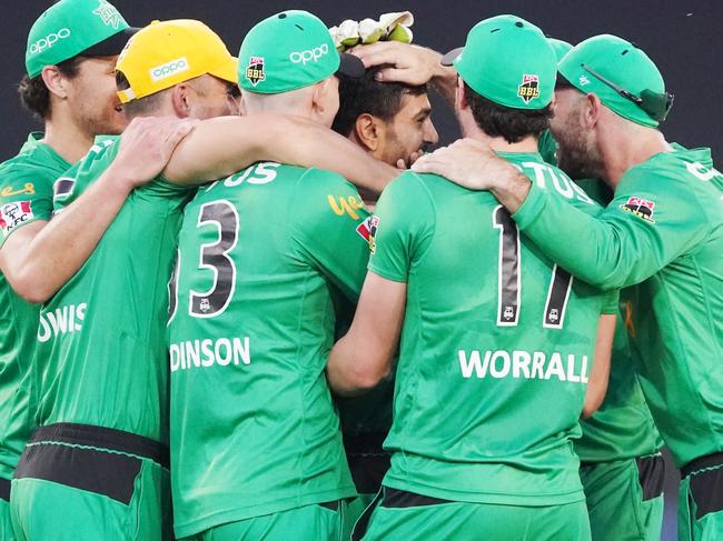 Teammates get around Rauf after his hat-trick at the MCG.