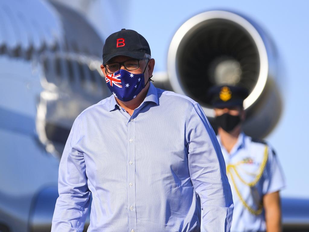 Australian Prime Minister Scott Morrison wears a face mask as he disembarks a plane after landing at Longreach Airport in Longreach. Picture: AAP Image/Lukas Coch/POOL via NCA NewsWire