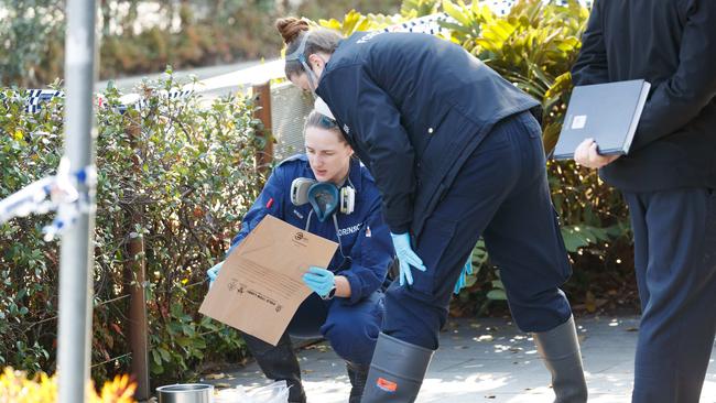 Police bag evidence at the scene. Picture: Max Mason-Hubers