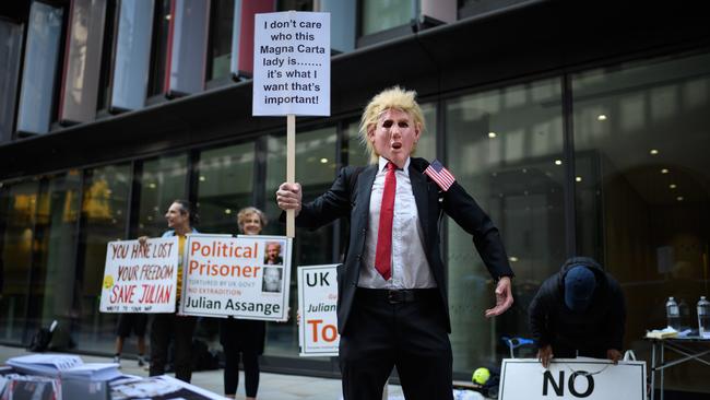 A Julian Assange supporter wears a Donald Trump mask outside the Old Bailey on in London on Monday. Pictures: Getty Images