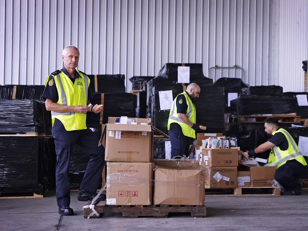 Australian Border Force Superintendent Graeme Campbell with other ABF officers and vaping products suspected of having illegal nicotine contents. Picture: Sam Ruttyn