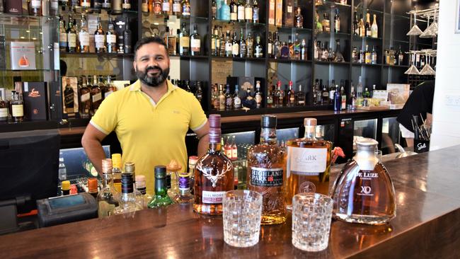 Amit Rana with some of the bottles from the top shelf whiskey collection at his venue at The Edge Apartment Hotel, restaurant TruFusion.