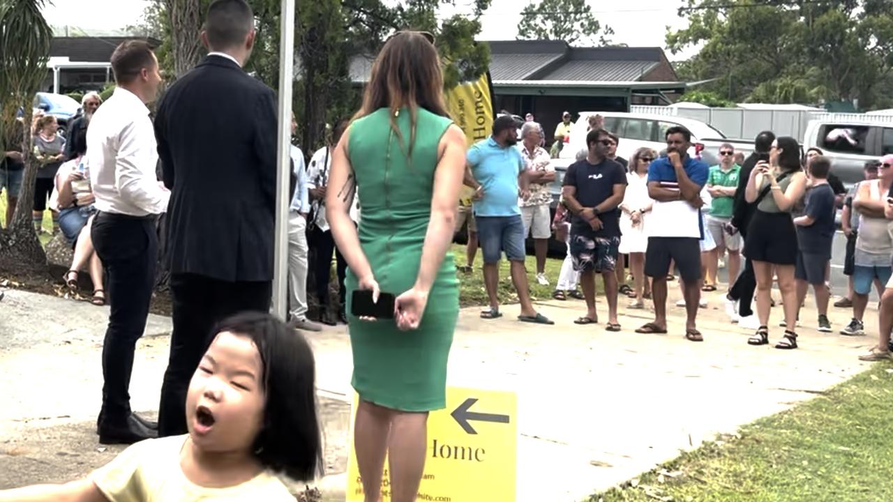 Auctioneer Justin Nickerson from Apollo Auctions was interrupted by a 'surprise guest' at the 23 Robert Stanley Drive, Mount Warren Park auction.