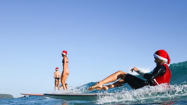 Swapping the sleigh for a surfboard was a great idea for Santa and his helpers. Photo: Luke Workman/@photo_13_ /Instagram