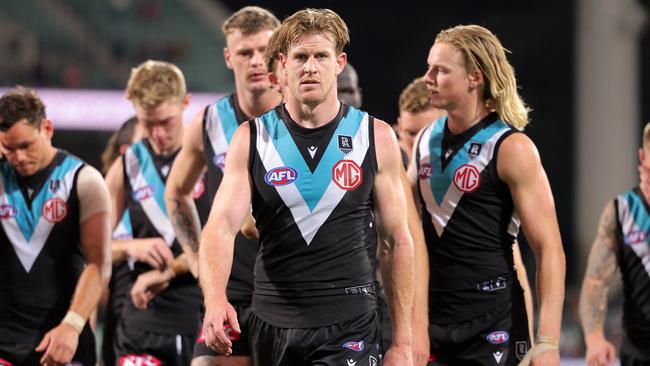 ADELAIDE, AUSTRALIA - MAY 15: Tom Jonas of the Power leads his team mates from the ground after the final siren during the round 9 AFL match between the Port Adelaide Power and the Western Bulldogs at Adelaide Oval on May 15, 2021 in Adelaide, Australia. (Photo by Daniel Kalisz/Getty Images)