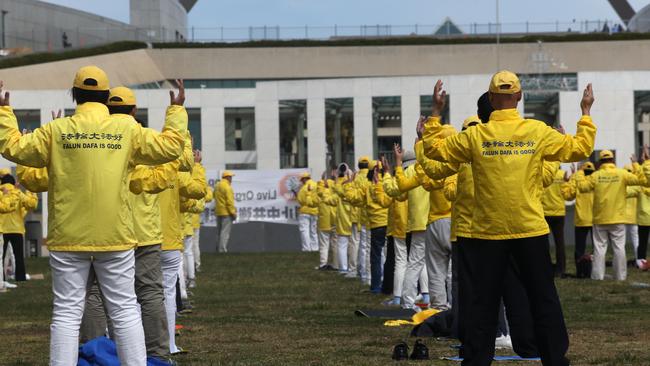 A silent protest from a group of Falun Gong during a peaceful meditation protest outside Parliament House in Canberra. Picture: Gary Ramage