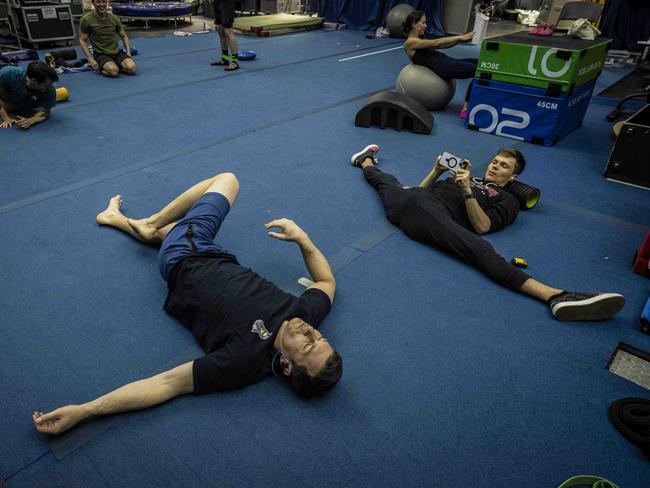 Performers – including contortionist Aleksei Goloborodko – stretch before rehearsal. Picture: Wayne Taylor