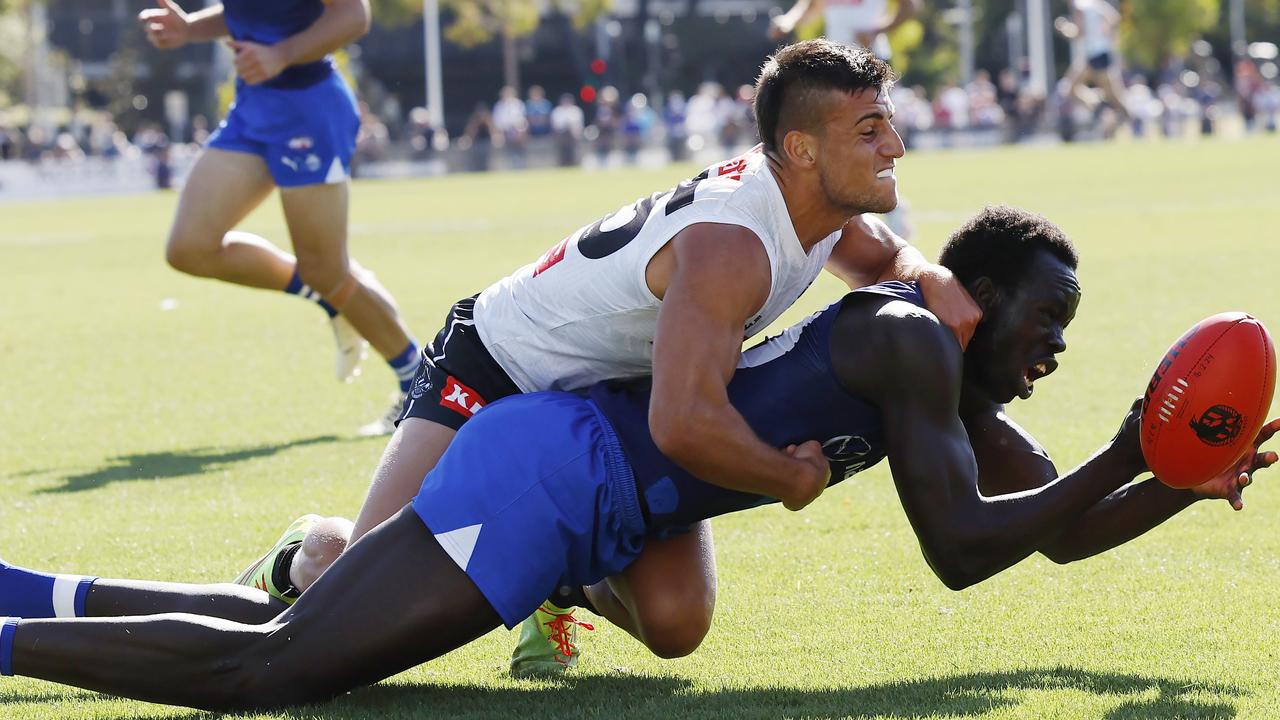 Bigoa Nyuon of the Kangaroos tackled by Nick Daicos. Picture: Michael Klein