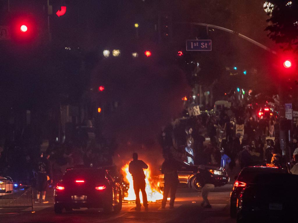 Protesters set trash cans on fire in front of City Hall during clashes with the police. Picture: Apu Gomes/Getty Images/AFP