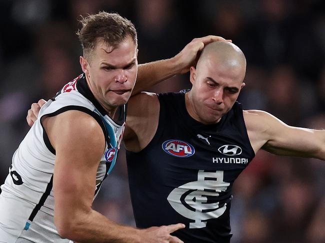 MELBOURNE, JULY 26, 2024: 2024 AFL Football - Round 20 - Carlton Blues V Port Adelaide Power at Marvel Stadium. Alex Cincotta of the Blues and Dan Houston of the Power  in action. Picture: Mark Stewart