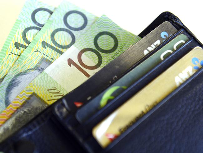 $100 Australian dollar notes pop out of a wallet with credit cards, pictured in Brisbane, Tuesday, Aug. 20, 2013. (AAP Image/Dan Peled) NO ARCHIVING