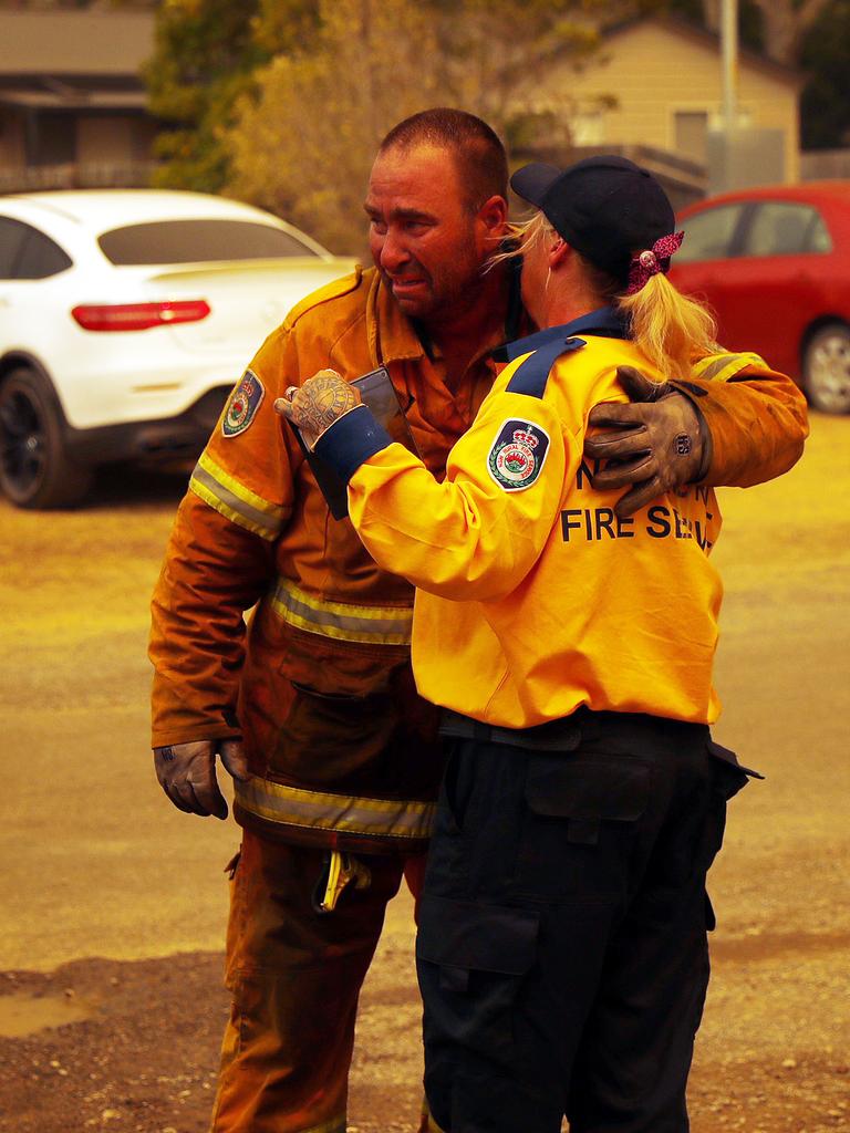 Scenery from the Balmoral area in greater south western Sydney which was hit hard today. RFS members Kathy and Matty Eyles pictured after Matty saved homes from burning down. Picture: Sam Ruttyn