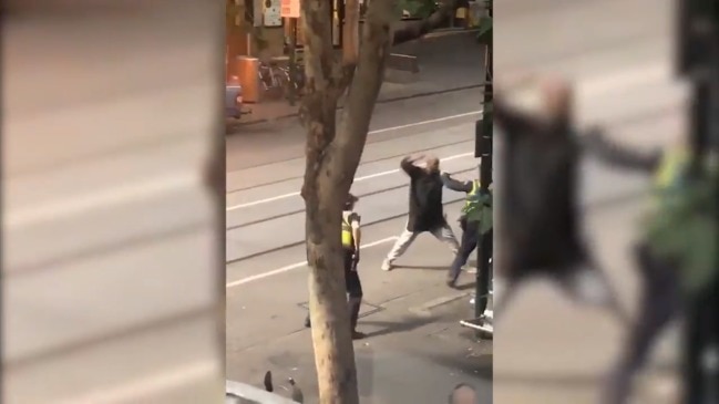 Police confront man with knife at Bourke Street