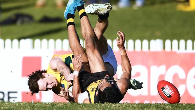 Rhyan Mansell catches Glenelg’s Marlion Motlop holding-the-ball. Picture: Mark Brake