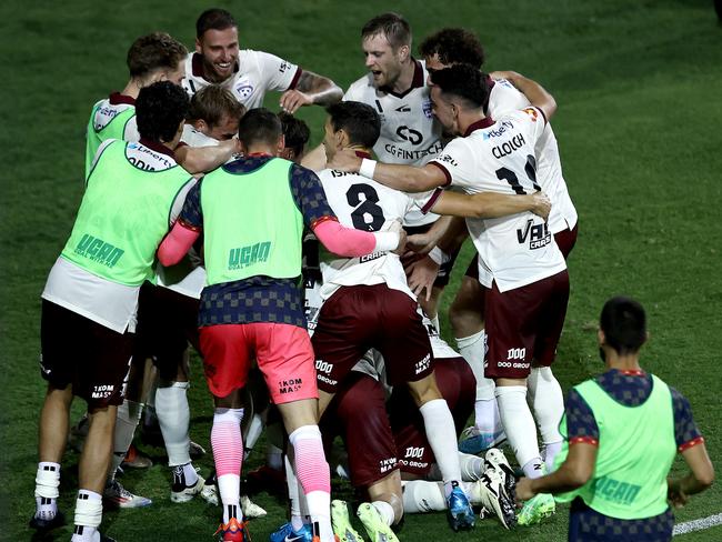 Adelaide United players swarm Luka Jovanovic. Picture: Matt Blyth/Getty Images