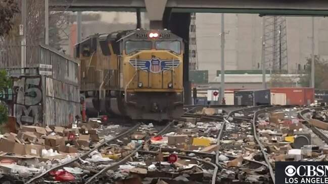 Shredded boxes and packages are seen at a section of the Union Pacific train tracks in downtown Los Angeles.