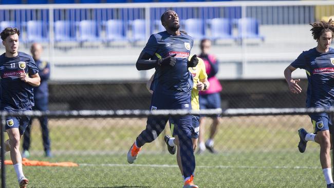 Usain Bolt stretches out during Mariners training on Wednesday. Picture: Dylan Robinson