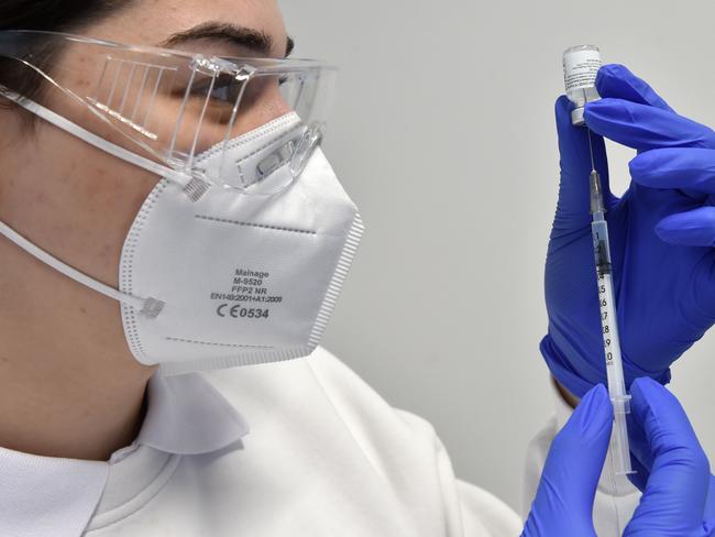 A health worker fills a syringe with the Pfizer-BioNTech COVID-19 vaccine. Picture: AFP