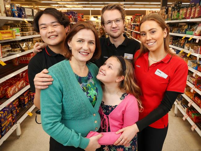 MELBOURNE, AUSTRALIA - NewsWire Photos SEPTEMBER 29, 2022 : Mary Brockhoff with her daughter Beth 11yrs, is reunited with Coles workers Roy Zeng , Connor Ferris and Emilia Cox at the Burwood East store. Mary collapsed of a heart attack while shopping with her daughter and the Coles workers kept her alive with CPR until emergency services arrived.  Picture NCA NewsWire / Ian Currie