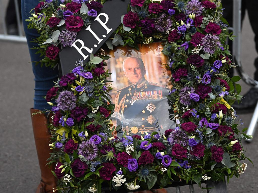 A wellwisher arrives to deliver a floral tribute to Prince Philip, at Windsor Castle in Windsor. Picture: AFP