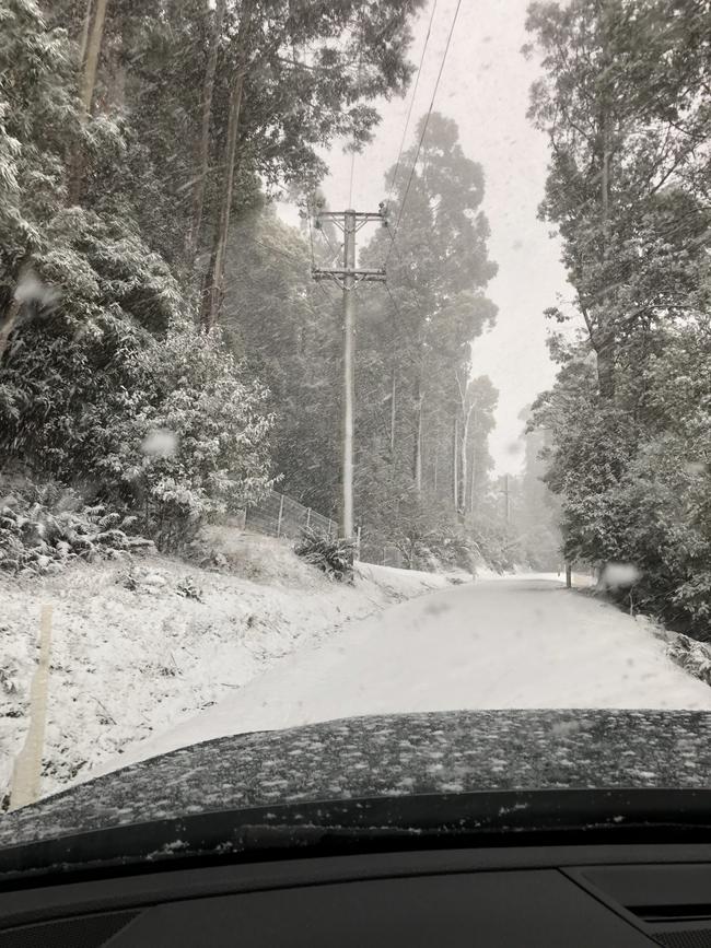 Snow on the road at Fern Tree.