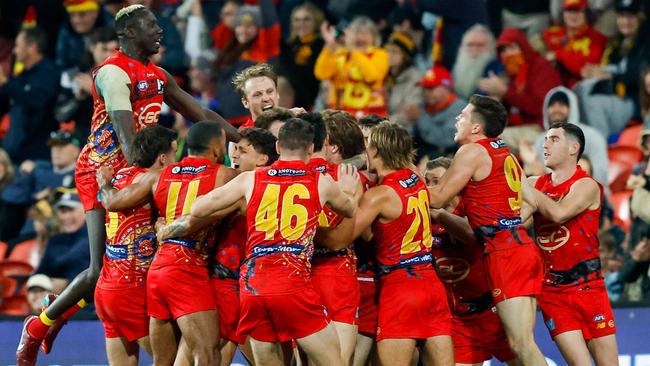 Every Sun mobbed their after-the-siren hero. Picture: AFL Photos/Getty Images