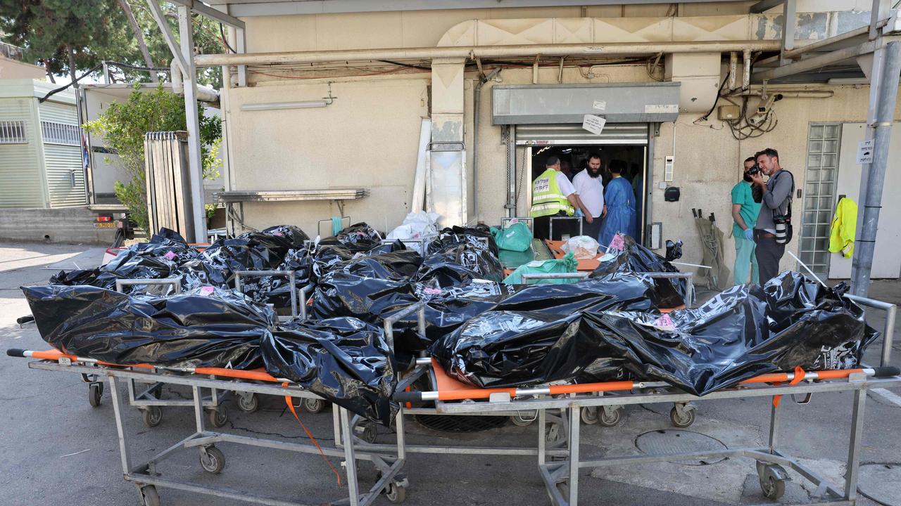 Bodies of people killed in the attack by Hamas militants await identification outside the National Centre for Forensic Medicine in Tel Aviv. Picture: AFP