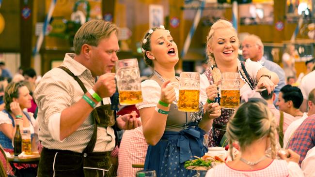 A group of young people in beer hall celebrating Oktoberfest on Theresienwiese before it was cancelled due to the Covid pandemic.