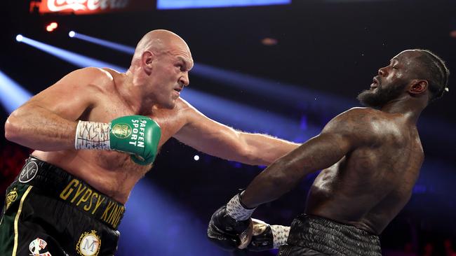 LAS VEGAS, NEVADA - FEBRUARY 22: Tyson Fury (L) punches Deontay Wilder during their Heavyweight bout for Wilder's WBC and Fury's lineal heavyweight title on February 22, 2020 at MGM Grand Garden Arena in Las Vegas, Nevada. (Photo by Al Bello/Getty Images)