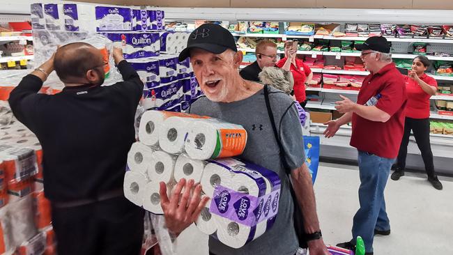 Toilet paper was in short supply in many places in Australia in March. This happy-looking shopper in Sydney got lucky. Picture: AAP