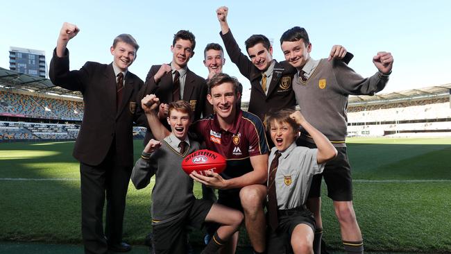 Andrews with a group of Padua College students at the Gabba. Picture: AAP Image/Josh Woning