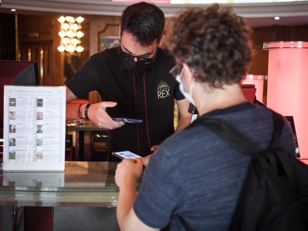 Movie-goers have their health passport checked before they enter cinemas in Paris.