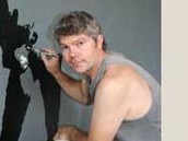 Dr Pierre Mol puts the finishing touches to a painting of Janis Joplin which will form part of a huge mural at the Buddha Bar and Restaurant at Byron Bay. Circa 2009