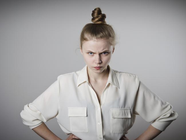 Angry young slim woman in white.