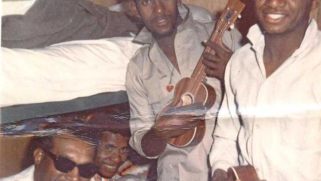 Historic: 1965: DOWNTIME: This photo was taken when Jeff Timor, right, first arrived in the remote workcamp near Tom Price to work on the construction of railways. The men created their own music with guitars and ukeles on weekends. From left are Mr Levi, "Saki" and Reggie Sailor.